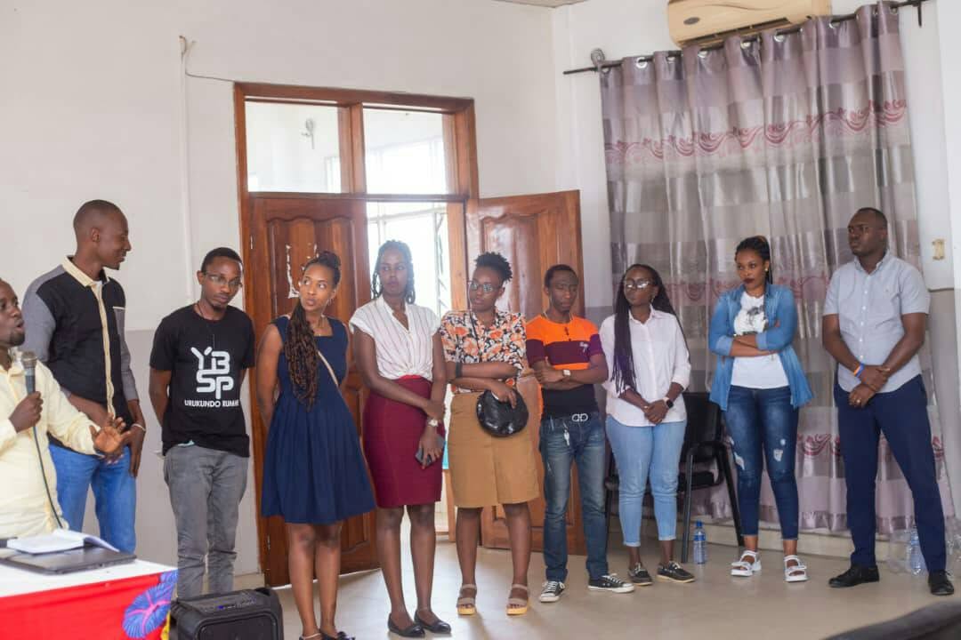 Young Burundian professionals posing together indoors at a YBSP mentorship cohort session