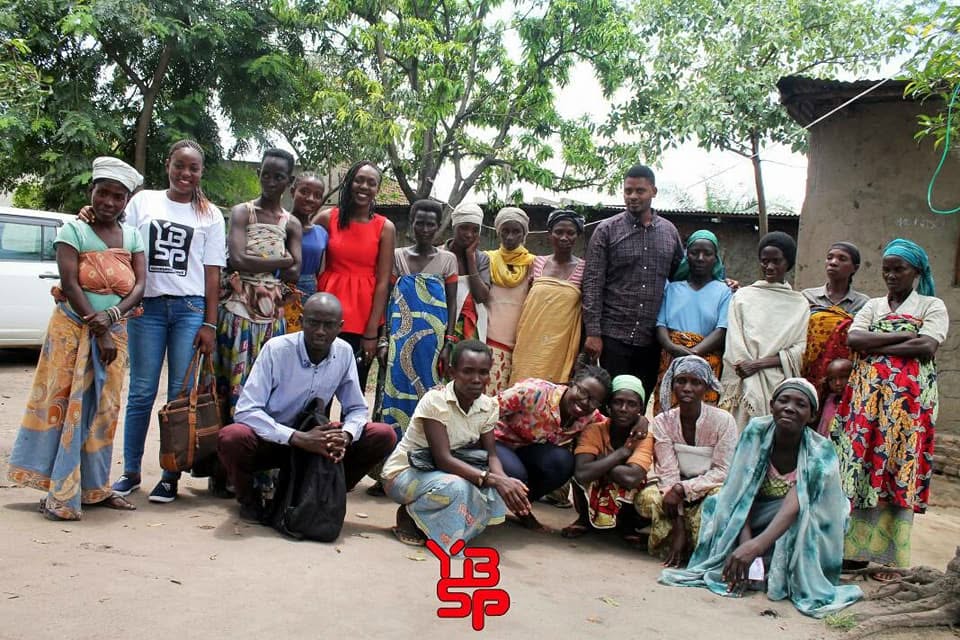 Group photo of the YBSP team with community women outdoors in Burundi