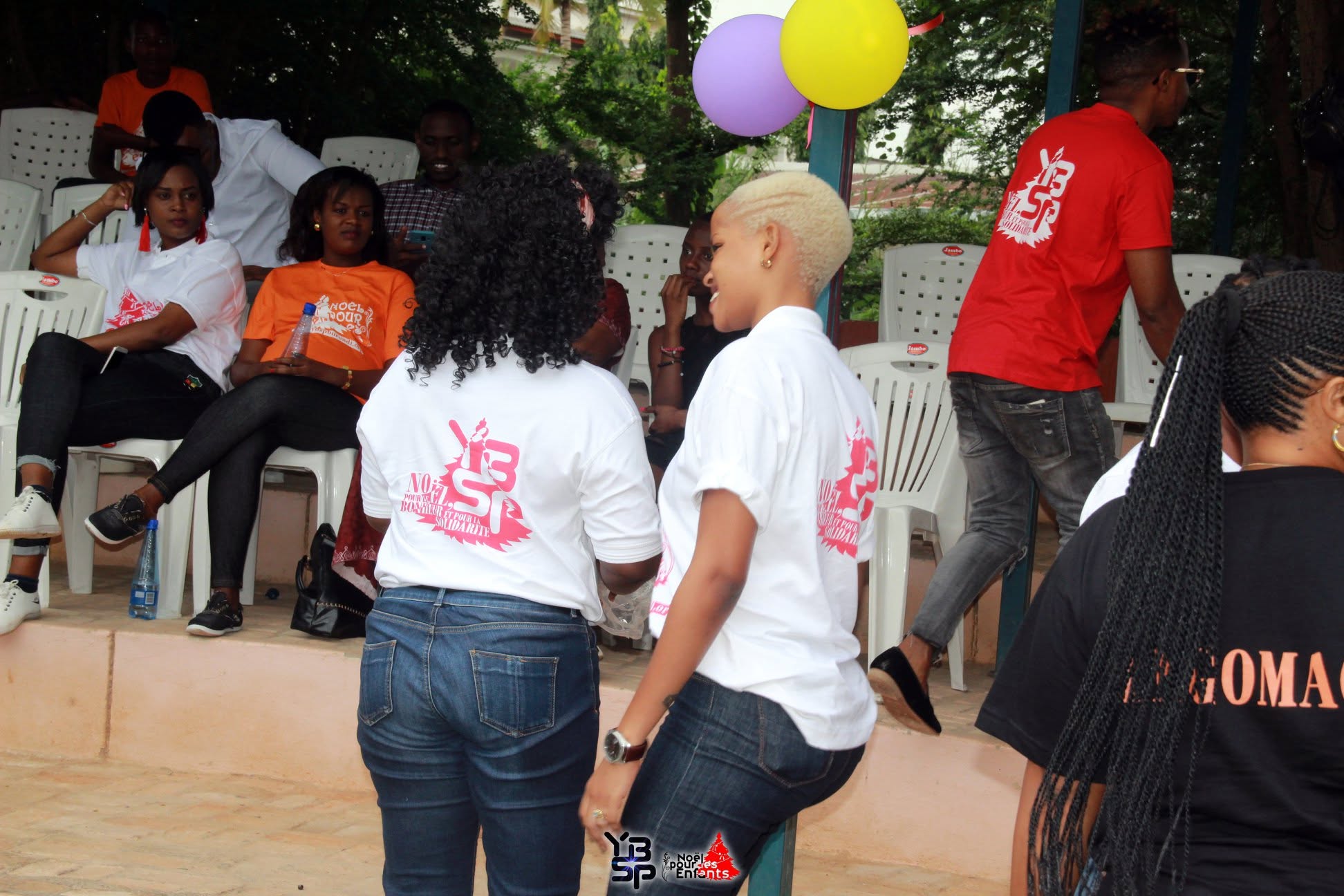 YBSP volunteers in branded shirts at an outdoor children's Christmas celebration in Burundi